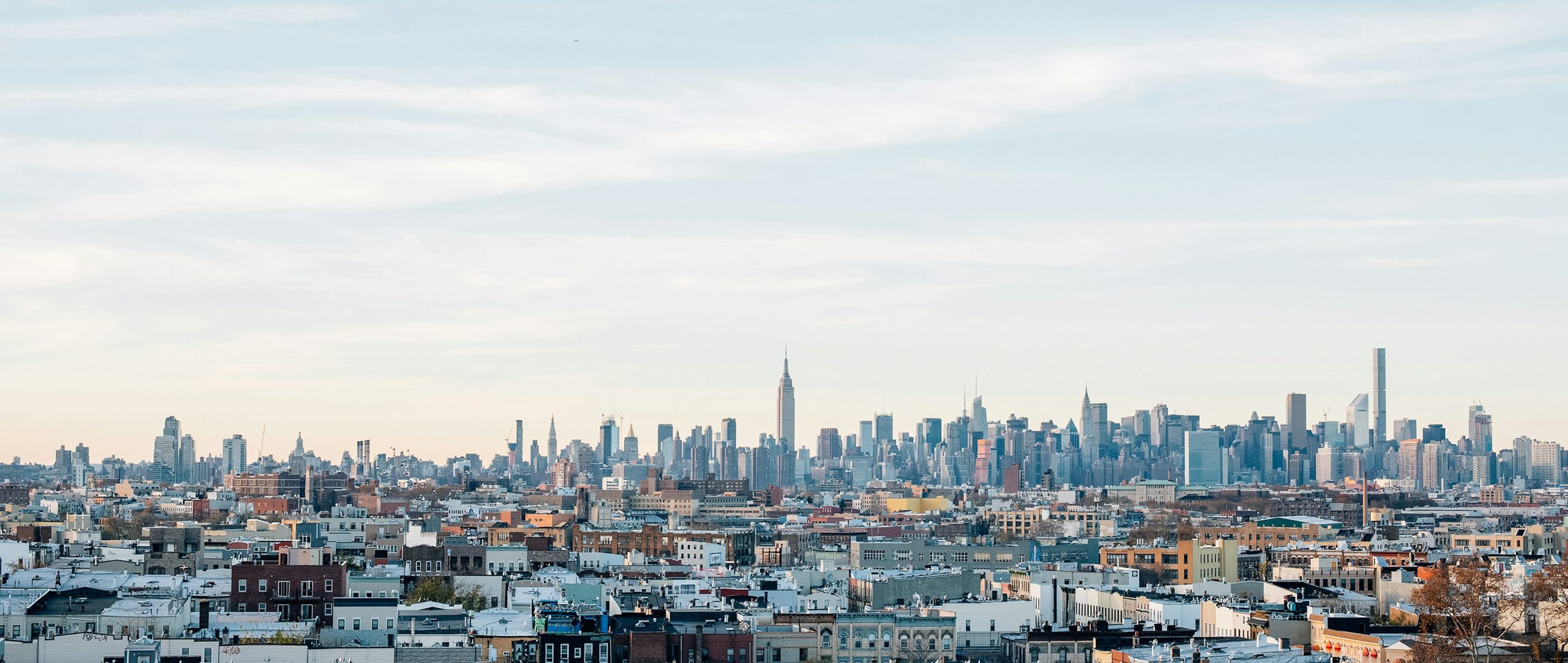Brooklyn and Queens rooftops running to the Manhattan skyline